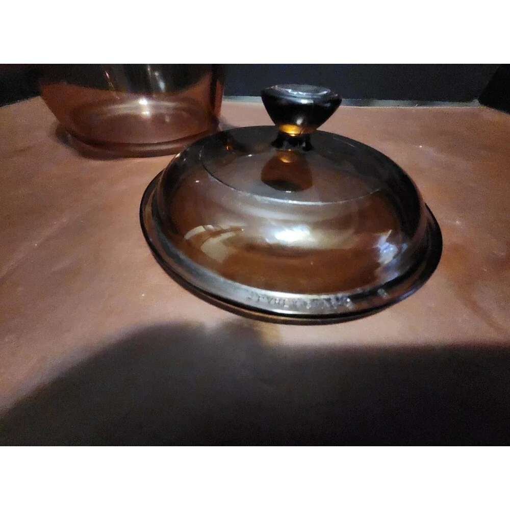 This item appears to be a vintage Corning Visions amber glass 1-liter...